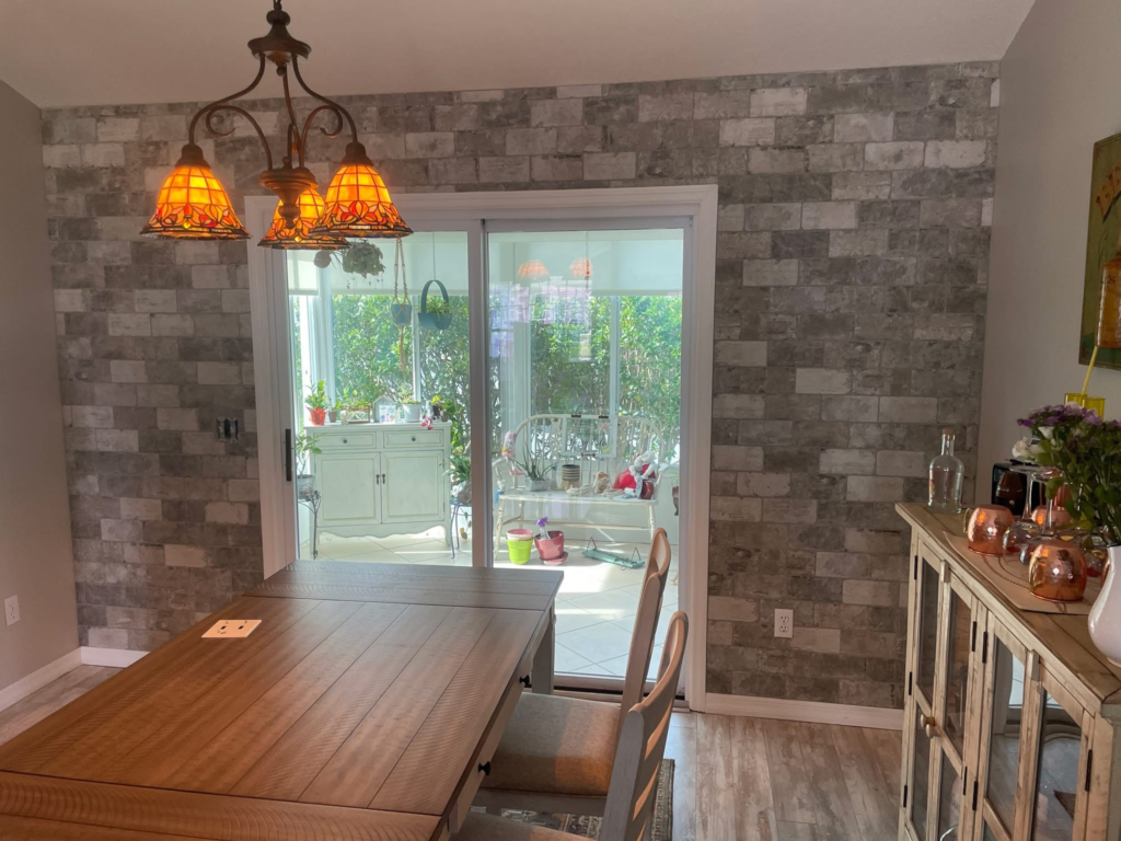 Custom ledger stone wall accentuation by CRB Services Pro, creating a warm, textured backdrop that elevates the entire dining area.