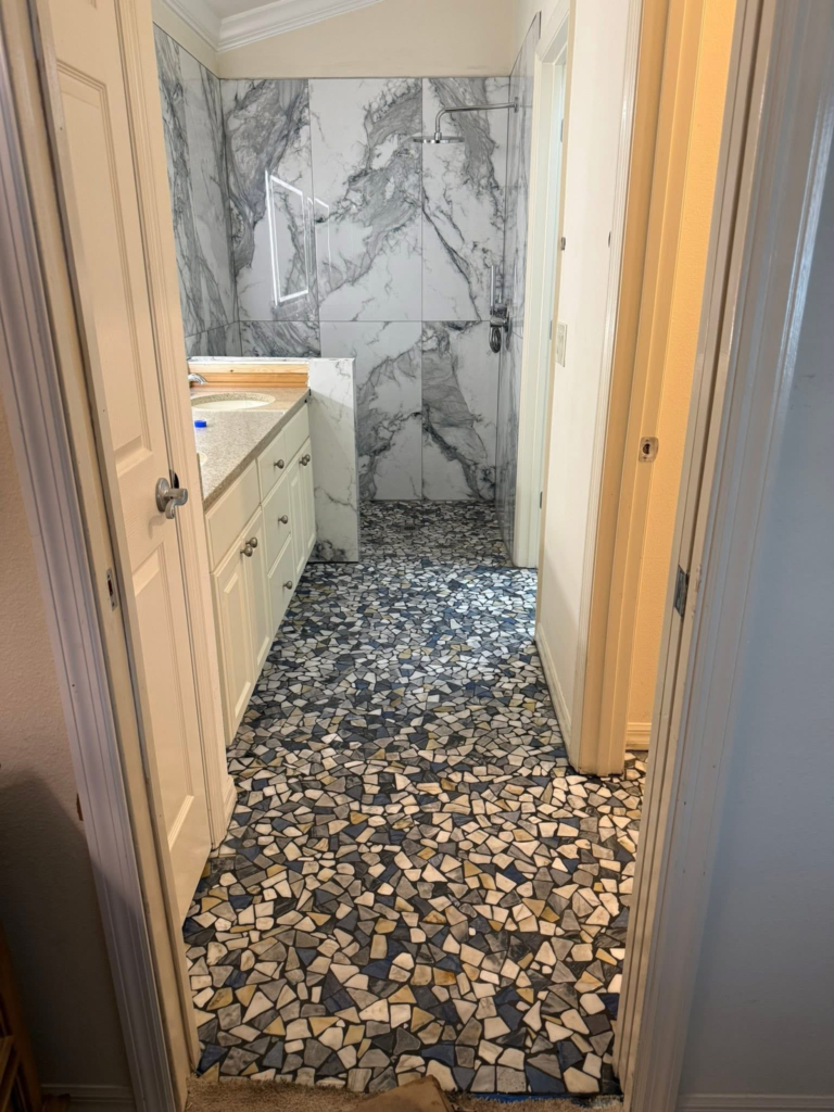 Bathroom floor and shower walls tiled by CRB Services Pro.
