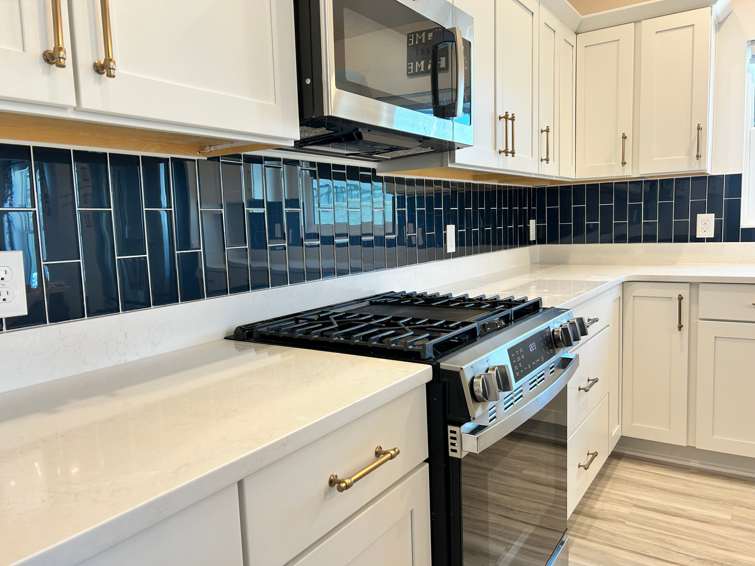 Contemporary vertical stack blue subway tile backsplash for a sleek, modern kitchen design.