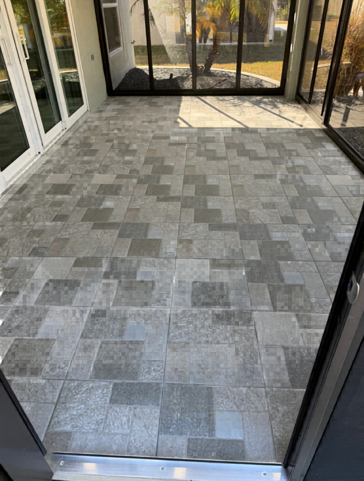This multi-toned gray tile installation delivers a clean, contemporary layout perfectly suited for screened patios and outdoor entertainment.
