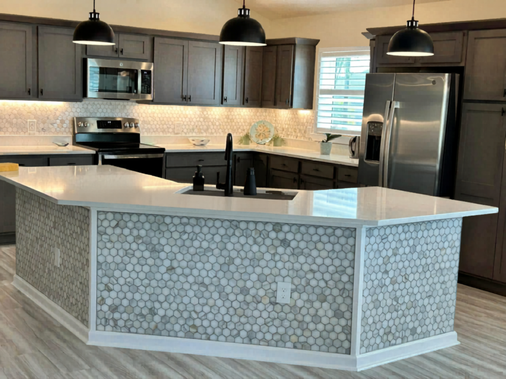 Geometric marble hexagon tile wrapped seamlessly around a custom kitchen island base for a sophisticated look in The Villages.