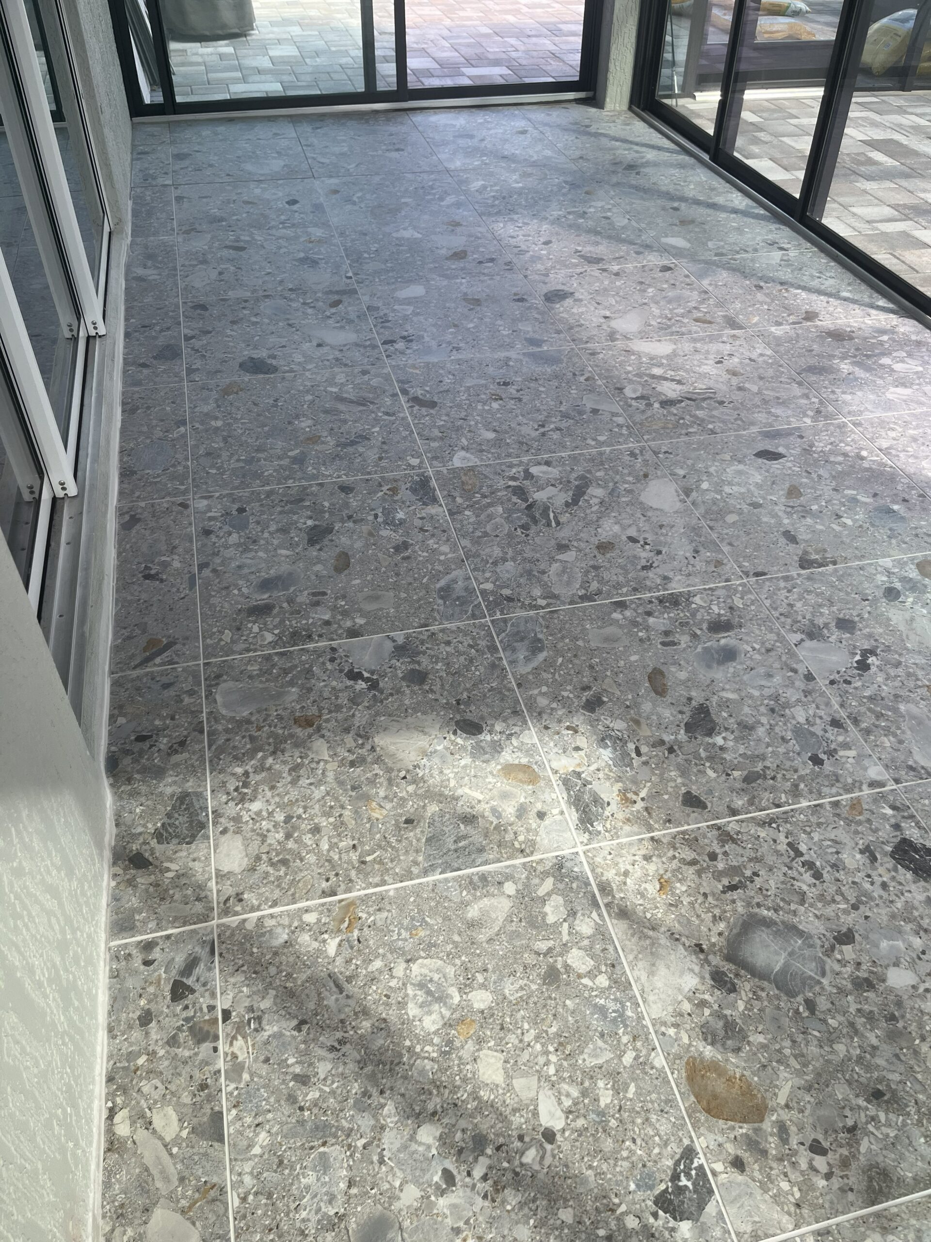 Featuring a sophisticated stone-inspired design, this porcelain tile floor combines beauty, strength, and lasting performance. Expert installation ensures smooth transitions, precise cuts, and a flawless finish throughout the entire outdoor living area.